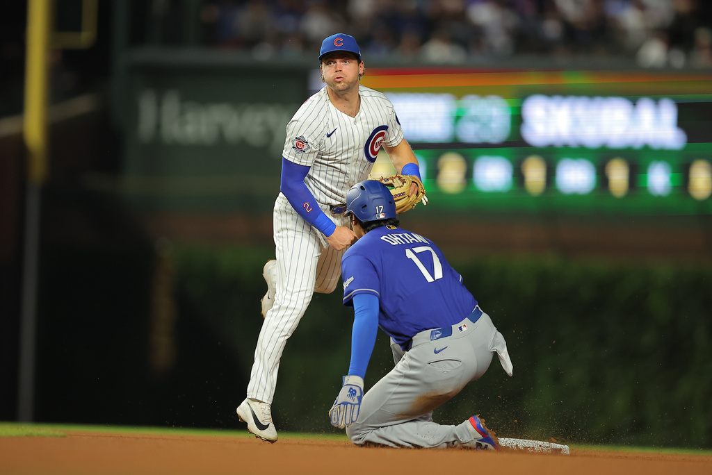 Chicago Cubs' Nico Hoerner throws into second base for a double during the sixth inning of a baseball game against the Los Angeles Dodgers, Tuesday, Aug. 4, 2026, in Chicago. (AP Photo/Melissa Tamez)