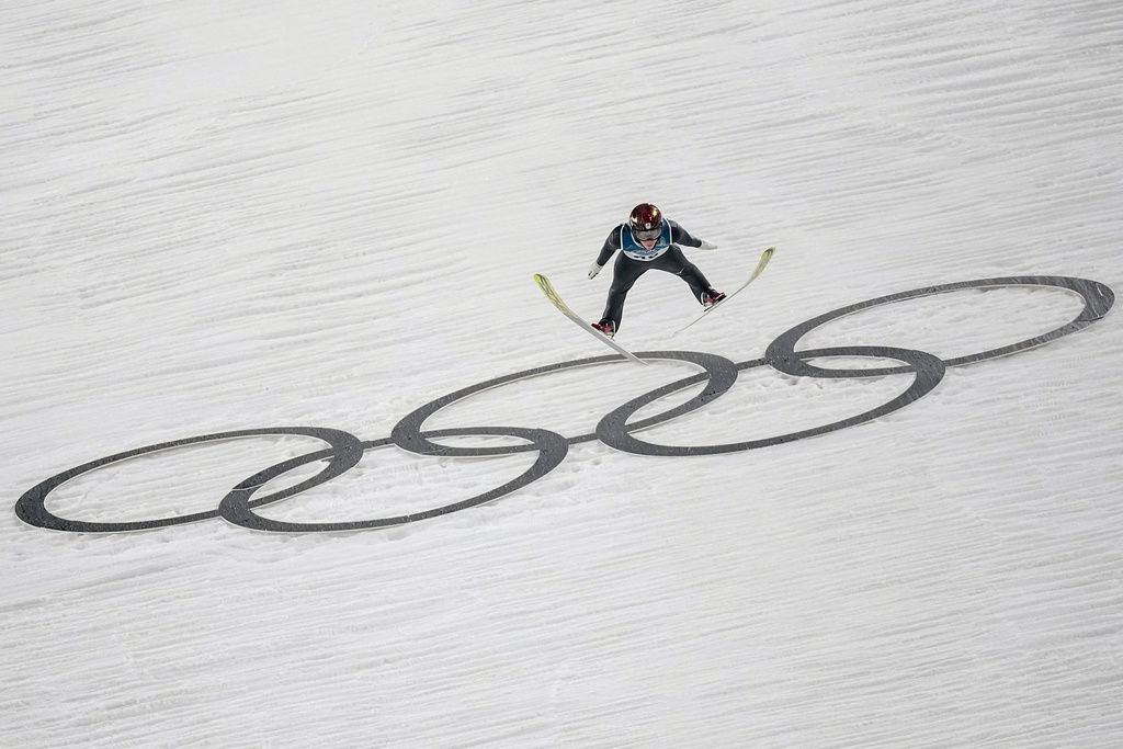 Ren Nikaido, of Japan, soars through the air during his first round jump of the ski jumping men's large hill individual at the 2026 Winter Olympics, in Predazzo, Italy, Saturday, Feb. 14, 2026. (AP Photo/Matthias Schrader)