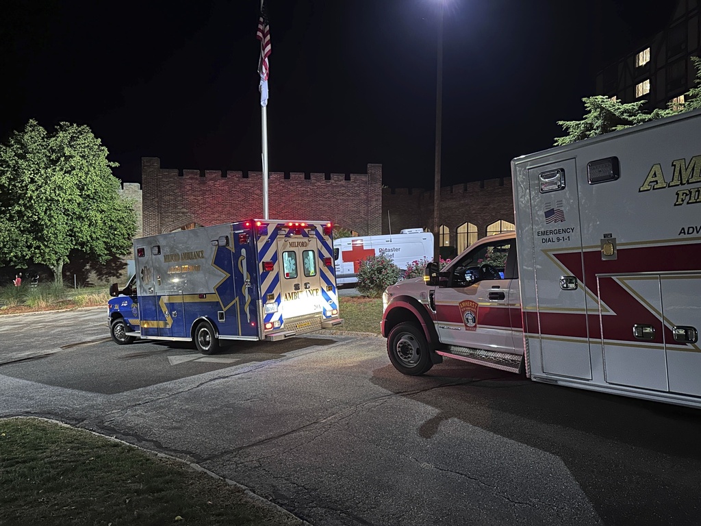 Ambulances are parked outside a hotel that is acting as a reunification center after a shooting at a country club in Nashua, New Hampshire, Saturday, Sept. 20, 2025. (AP Photo/Michael Casey)