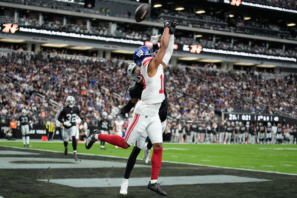 Las Vegas Raiders cornerback Darien Porter (26) breaks up a pass intended for New York Giants wide receiver Darius Slayton (18) during the first half of an NFL football game Sunday, Dec. 28, 2025, in Las Vegas. (AP Photo/John Locher)