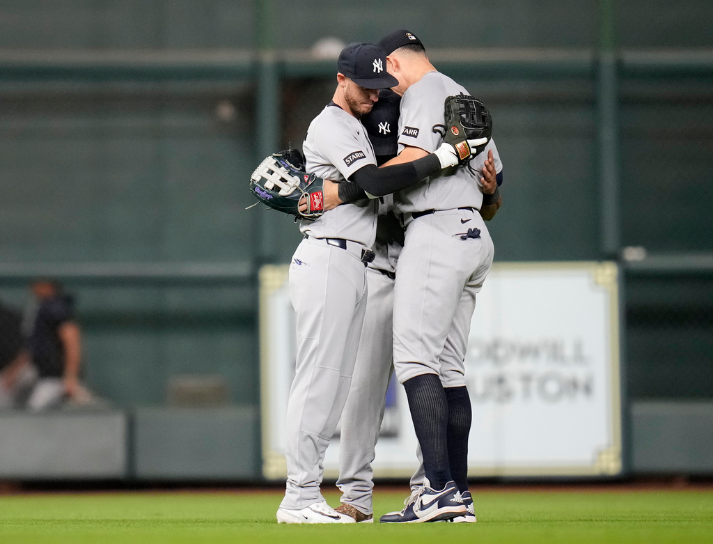 New York Yankees' Cody Bellinger, left, hugs Aaron Judge, right, after their team's victory over the Houston Astros in a baseball game, Saturday, April 25, 2026, in Houston. (AP Photo/Karen Warren)
