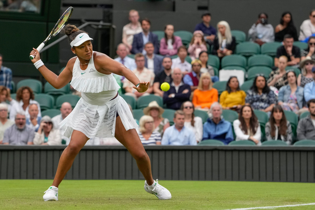 FILE - Naomi Osaka, of Japan, plays a forehand return to Emma Navarro, of the United States, during their match on day three at the Wimbledon tennis championships in London, July 3, 2024. (AP Photo/Alberto Pezzali)