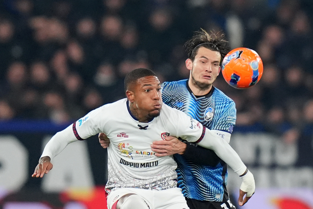 Atalanta's Berat Djimsiti, right, and Cagliari's Semih Kilicsoy, left, challenge for the ball during the Serie A soccer match between Atalanta Bergamo and Cagliari Calcio in Bergamo, Italy, Saturday Dec. 13, 2025. (Spada/LaPresse via AP)