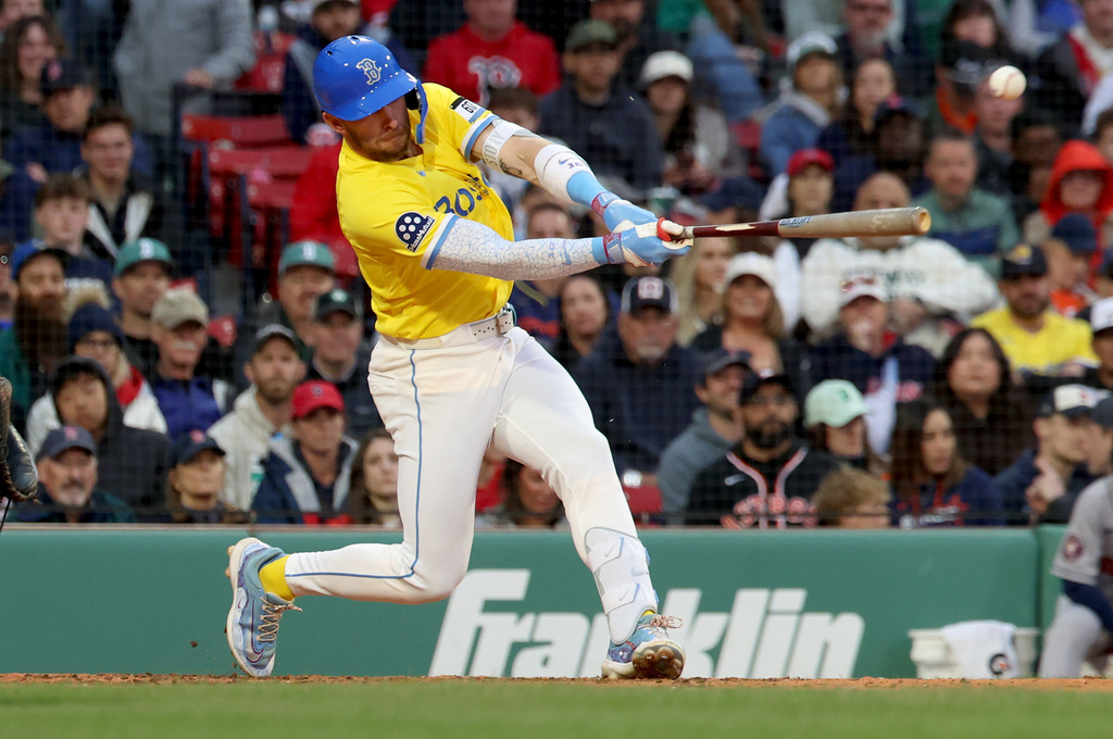 Boston Red Sox's Trevor Story hits an RBI single in the seventh inning of a baseball game against the Houston Astros, Saturday, May 2, 2026, in Boston. (AP Photo/Mark Stockwell)