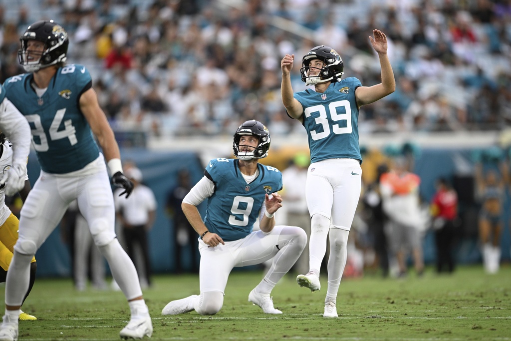 Jacksonville Jaguars place kicker Cam Little kicks a field goal out of the hold of punter Logan Cooke during the first half of an NFL preseason football game against the Pittsburgh Steelers, Saturday, Aug. 9, 2025, in Jacksonville, Fla. (AP Photo/Phelan M. Ebenhack)