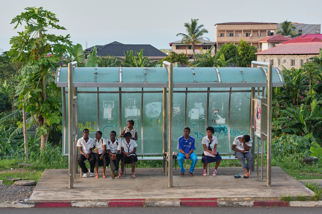Students wait at a bus stop, in Malabo, Equatorial Guinea, Monday, April 20, 2026. (AP Photo/Misper Apawu)