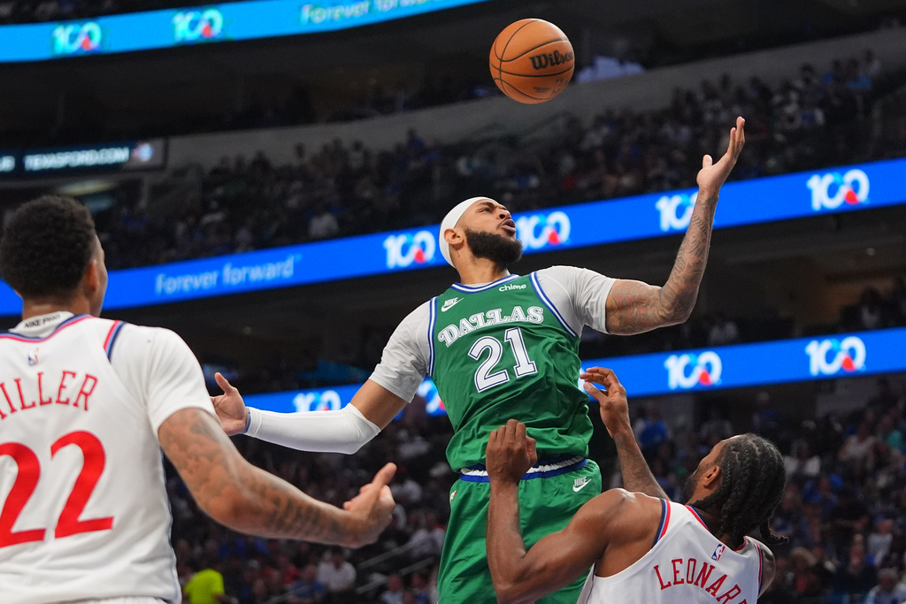 Dallas Mavericks forward Daniel Gafford (21) jumps for the rebound against Los Angeles Clippers forward Kawhi Leonard (2) and guard Jordan Miller (22) during the first half of an NBA basketball game in Dallas, Saturday, March 21, 2026. (AP Photo/LM Otero)