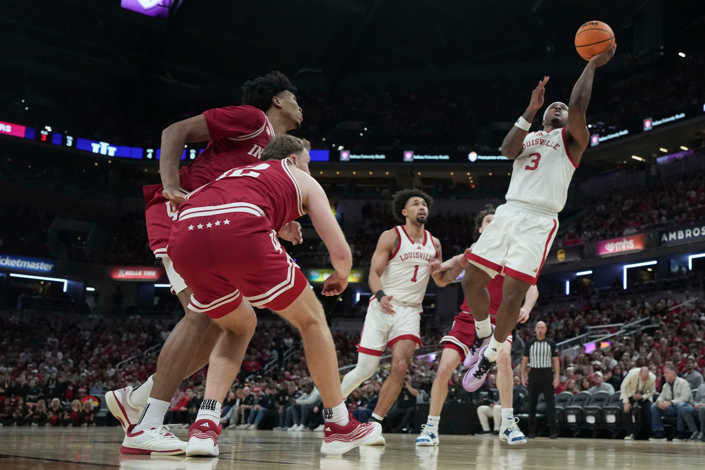 Louisville guard Ryan Conwell (3) shoots in front of Indiana forward Tucker Devries (12) during an NCAA college basketball game in Indianapolis, Saturday, Dec. 6, 2025. (AP Photo/AJ Mast)