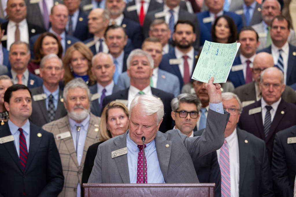 House Speaker Jon Burns holds up proposed property tax relief legislation during a press conference at the Capitol in Atlanta on Wednesday, Jan. 28, 2026. (Arvin Temkar /Atlanta Journal-Constitution via AP)