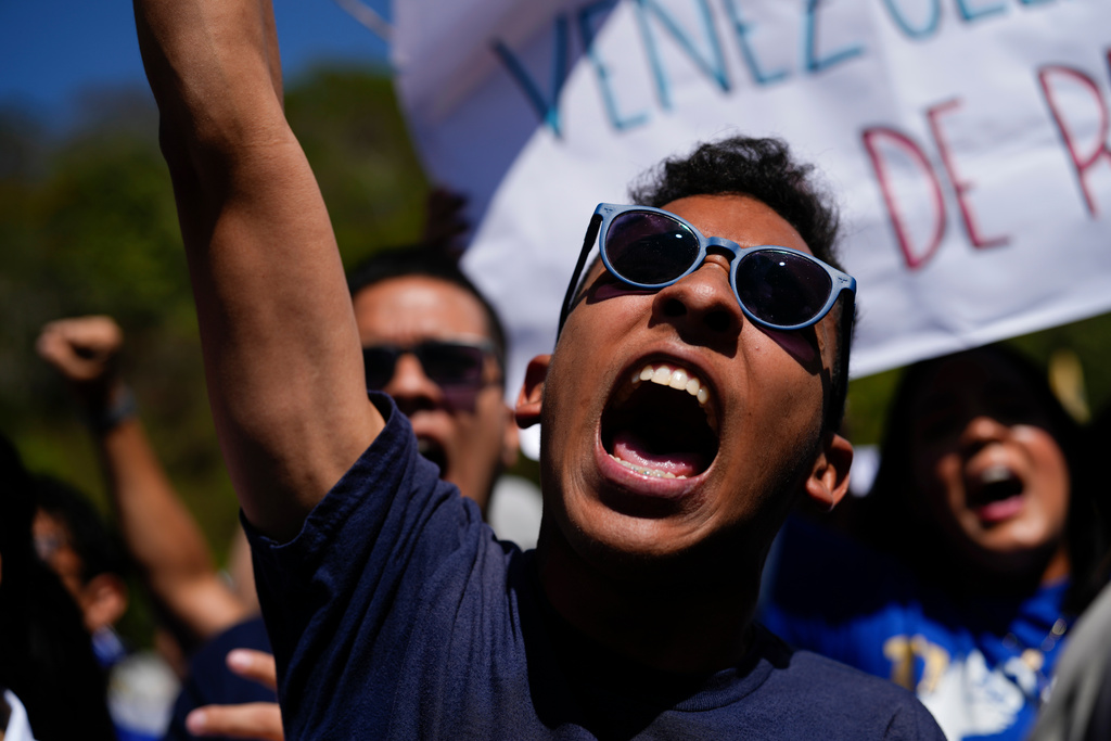 People attend a student-led march on National Youth Day to call for the release of detainees, considered to be political prisoners by their relatives and human rights groups, in Caracas, Venezuela, Thursday, Feb. 12, 2026. (AP Photo/Ariana Cubillos)