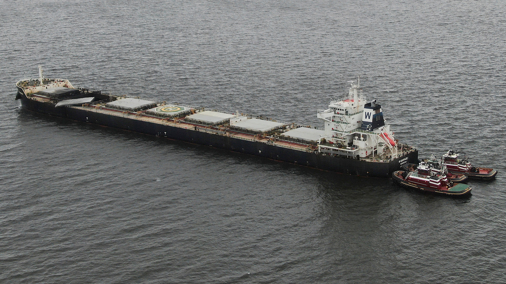 A Liberian commercial cargo vessel named W-Sapphire, that had an explosion late Monday on-board, is towed by tugboats near the Sandy Point Shoal Light in Annapolis, Md., Tuesday, Aug. 19, 2025, off the shore of the Sandy Point State Park. (Jeffrey F. Bill/The Baltimore Sun via AP)