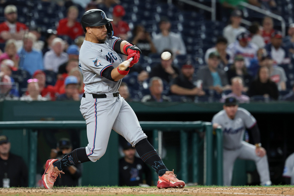 Miami Marlins' Heriberto Hernández hits a two-run home run off Washington Nationals pitcher Mitchell Parker which also scored Jakob Marsee during the ninth inning of a baseball game, Tuesday, June 2, 2026, in Washington. (AP Photo/Terrance Williams)