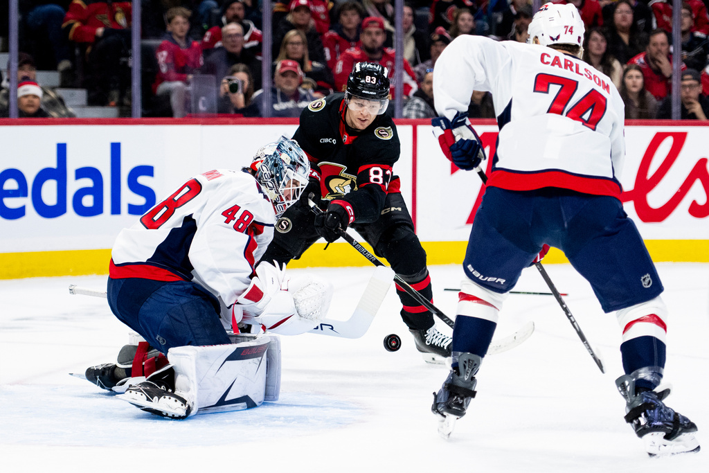 Ottawa Senators' Stephen Halliday (83) fights for control of the puck in front of Washington Capitals goalie Logan Thompson (48) during second period NHL hockey action on New Year's Day in Ottawa, on Thursday, Jan. 1, 2026. (Spencer Colby/The Canadian Press via AP)