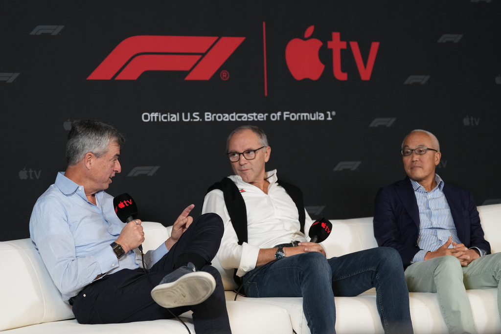 Apple's Eddy Cue, Senior Vice President of Services, left, F1 chairman Stefano Domenicali, center, and Derek Chang, CEO of Liberty Media, right, discuss a five-year partnership with Formula 1 and Apple TV to bring races to its streaming service beginning in 2026 during a news conference at the Circuit of the Americas in Austin, Texas, Friday, Oct. 17, 2025. (AP Photo/Eric Gay)