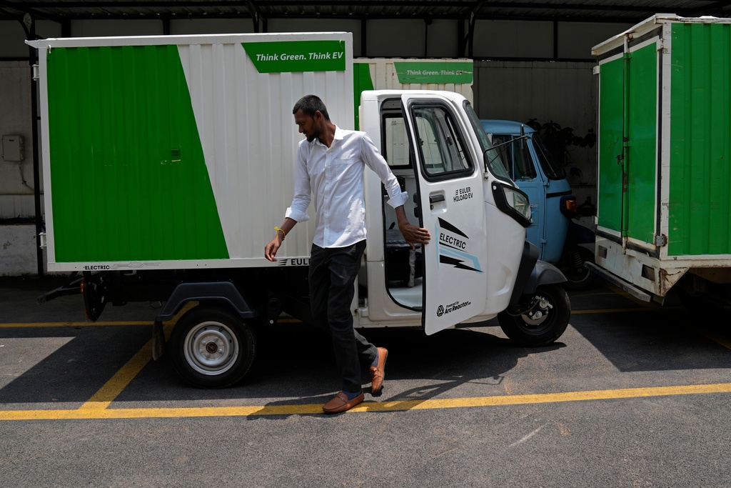 FILE - An electric rickshaw delivery driver exits after parking the vehicle at logistics company City Link in Bengaluru, India, May 31, 2023. (AP Photo/Aijaz Rahi, File)