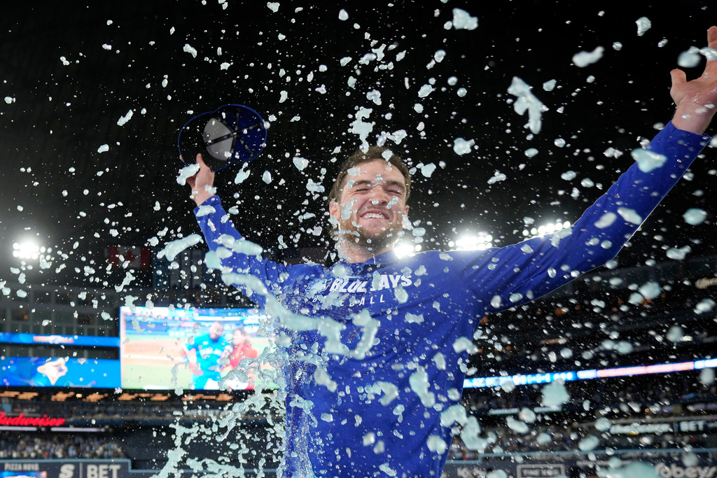 Toronto Blue Jays pitcher Trey Yesavage is doused by teammate Myles Straw after their team's win over the New York Yankees in Game 2 of baseball's American League Division Series in Toronto, Sunday, Oct. 5, 2025. (Frank Gunn/The Canadian Press via AP)