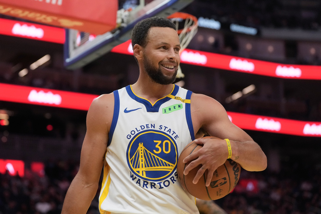 Golden State Warriors guard Stephen Curry (30) smiles during the second half of a preseason NBA basketball game against the Portland Trail Blazers, Friday, Oct. 16, 2026, in San Francisco. (AP Photo/Jeff Chiu)