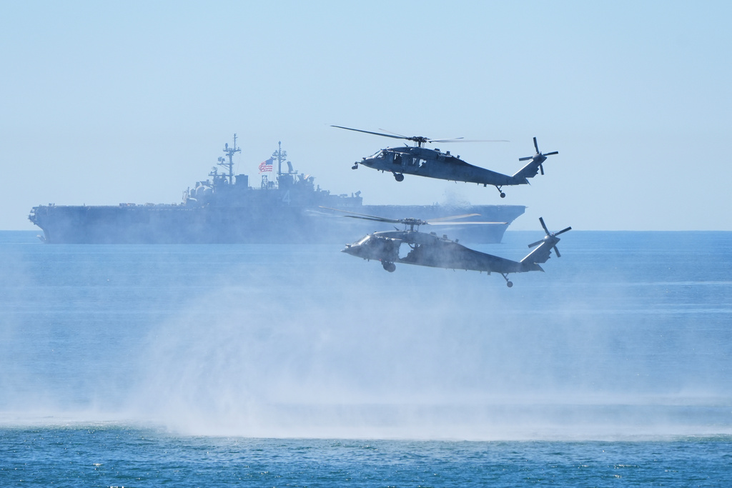 Marines perform a demonstration with helicopters and the amphibious assault ship USS Boxer as Vice President JD Vance, not pictured, watches to mark the upcoming Marine Corps' 250th anniversary Saturday, Oct 18, 2025, on Marine Corps Base Camp Pendleton in Camp Pendleton, Calif. (AP Photo/Gregory Bull)
