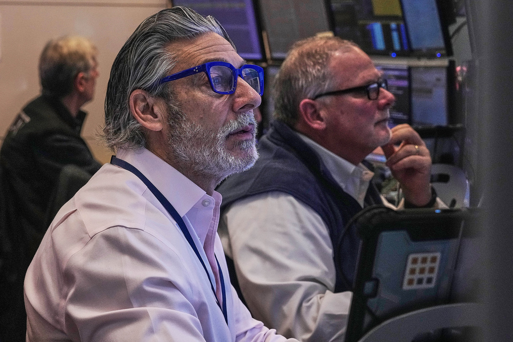 Traders John Romolo, left, and Michael Conlon work on the floor of the New York Stock Exchange, Thursday, Jan. 22, 2026. (AP Photo/Richard Drew)