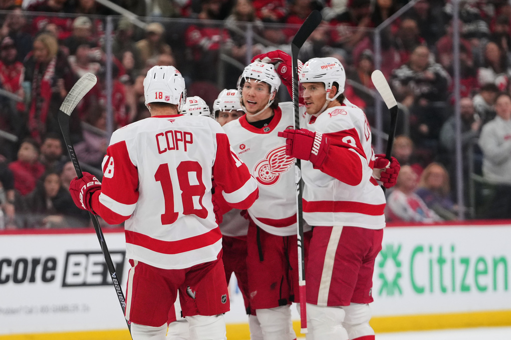 iDetroit Red Wings' Moritz Seider, center, celebrates with teamates after scoring a goal during the first period of an NHL hockey game against the New Jersey Devils Sunday, March 8, 2026, in Newark, N.J. (AP Photo/Frank Franklin II)