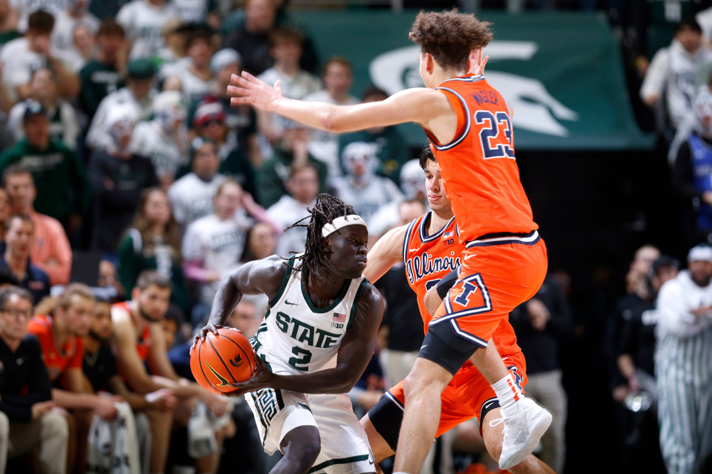 Illinois guards Keaton Wagler (23) and Andrej Stojakovic, back right, pressure Michigan State guard Kur Teng (2) during the first half of an NCAA college basketball game, Saturday, Feb. 7, 2026, in East Lansing, Mich. (AP Photo/Al Goldis)