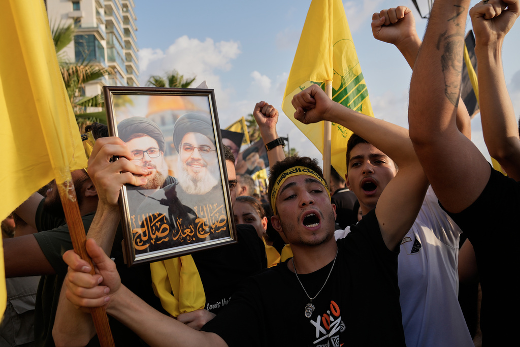 Hezbollah supporters shout slogans during an event commemorating the anniversary of the assassination of Hezbollah leader Sayyed Hassan Nasrallah in Beirut, Lebanon, Thursday, Sept. 25, 2025. (AP Photo/Hussein Malla)