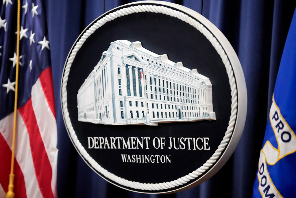 FILE - The logo for the Justice Department is seen before a news conference at the Department of Justice on Aug. 23, 2024, in Washington. (AP Photo/Mark Schiefelbein, File)