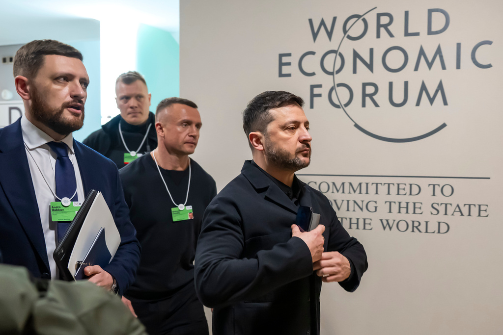 Ukraine's President Volodymyr Zelenskyy, right, arrives for the Annual Meeting of the World Economic Forum in Davos, Switzerland, Thursday, Jan. 22, 2026. (Laurent Gillieron/Keystone via AP)