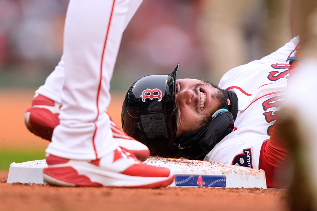 Boston Red Sox right fielder Wilyer Abreu (52) grimaces after being hit by a throw to first base by San Diego Padres pitcher Walker Buehler during the second inning of a baseball game, Sunday, April 5, 2026, in Boston. (AP Photo/Robert F. Bukaty)
