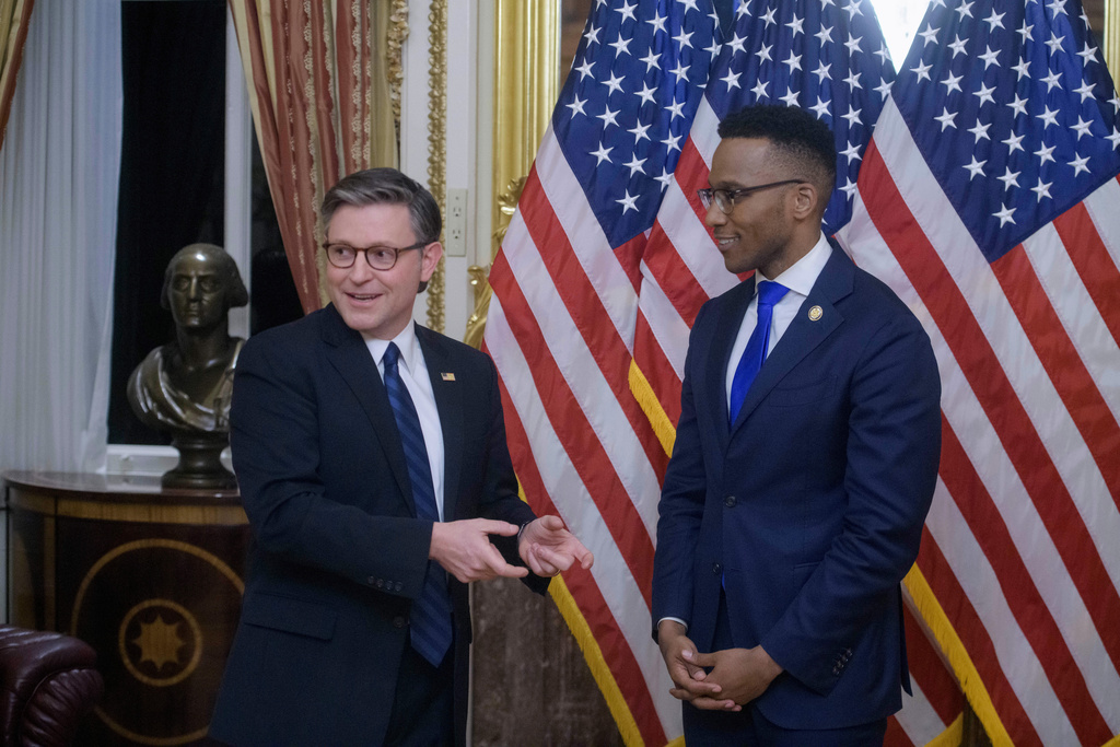 Speaker of the House Mike Johnson, R-La., left, talks with Rep. Christian Menefee, D-Texas, right, during a ceremonial swearing-in at the Capitol, Monday, Feb. 2, 2026, in Washington. (AP Photo/Rod Lamkey, Jr.)