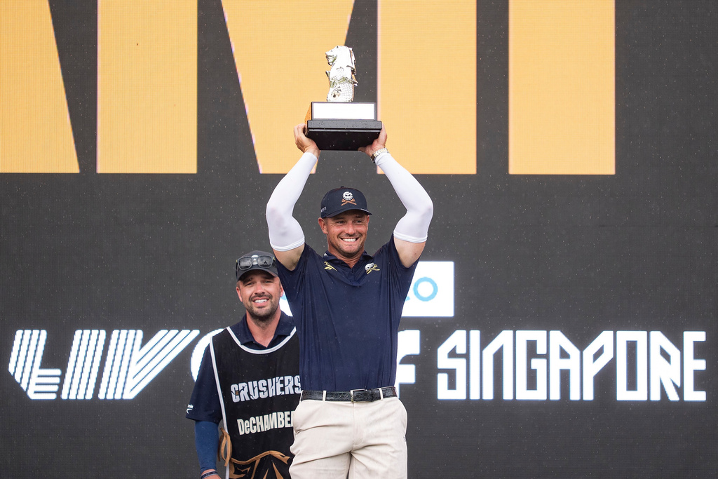 First place individual champion, Captain Bryson DeChambeau of Crushers GC, holds the trophy during the trophy ceremony after the final round of Aramco LIV Golf Singapore on Sunday, March 15, 2026 in Sentosa, Singapore. (Mateo Villalba/LIV Golf via AP)