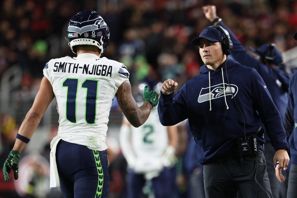 Seattle Seahawks wide receiver Jaxon Smith-Njigba (11) is congratulated by head coach Mike Macdonald during the first half of an NFL football game against the San Francisco 49ers in Santa Clara, Calif., Saturday, Jan. 3, 2026. (AP Photo/Jed Jacobsohn)