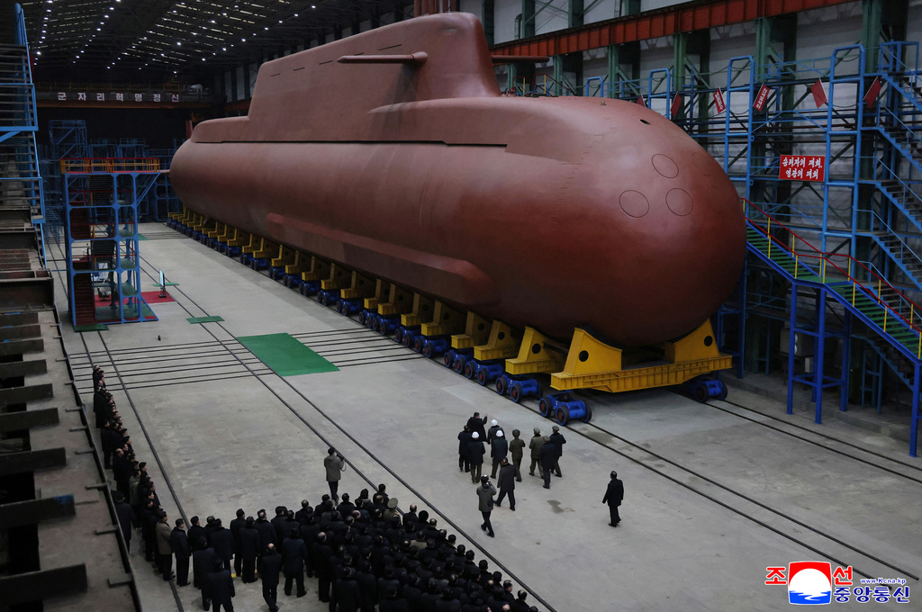 In this undated photo provided Thursday, Dec. 25, 2025, by the North Korean government, its leader Kim Jong Un inspects a nuclear-powered submarine under construction at an undisclosed location in North Korea. Independent journalists were not given access to cover the event depicted in this image distributed by the North Korean government. The content of this image is as provided and cannot be independently verified. Korean language watermark on image as provided by source reads: "KCNA" which is the abbreviation for Korean Central News Agency. (Korean Central News Agency/Korea News Service via AP)