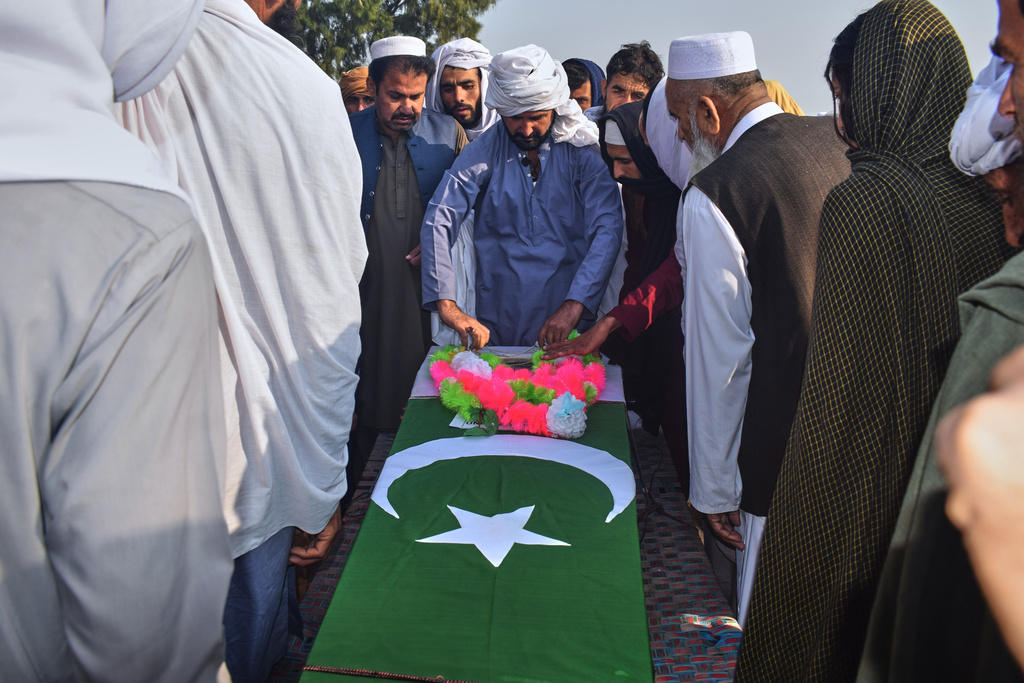 People gather around the coffin of an army soldier, killed in the cross-border clashes of Pakistan and Afghan forces, during a funeral prayer in a village in Lakki Marwat, a district of Pakistan's Khyber Pakhtunkhwa province, Saturday, Feb. 28, 2026. (AP Photo/G.A. Marwat)