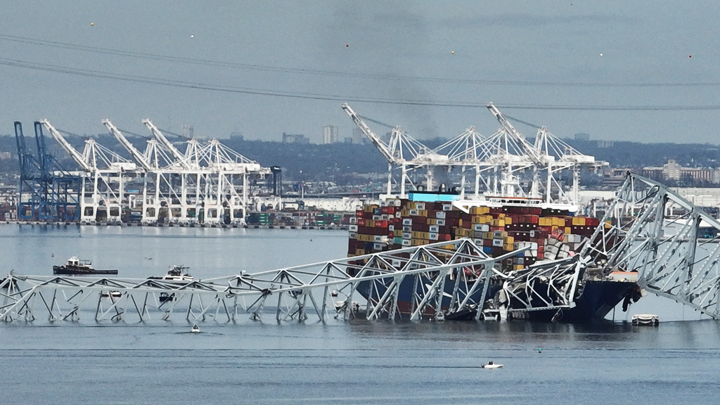 FILE - A cargo ship is stuck under the part of the structure of the Francis Scott Key Bridge after the ship hit the bridge, March 26, 2024, in Baltimore, Md. (AP Photo/Steve Helber, File)