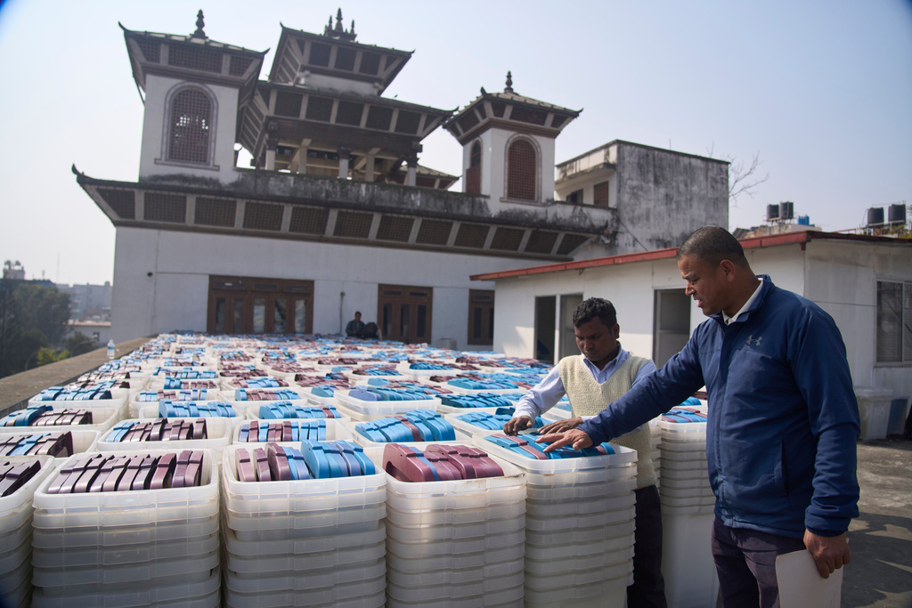 FILE - Election Commission staff inspect ballot boxes before loading onto a vehicle for delivery to various regions across the country ahead of the March 5 general election in Kathmandu, Nepal, on Feb. 8, 2026. (AP Photo/Niranjan Shrestha, File)