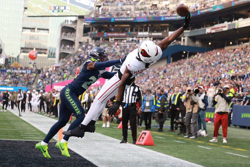 Arizona Cardinals wide receiver Marvin Harrison Jr, right, leaps in vain for a pass as Seattle Seahawks cornerback Devon Witherspoon defends during the second half of an NFL football game Sunday, Nov. 9, 2025, in Seattle. (AP Photo/Maddy Grassy)