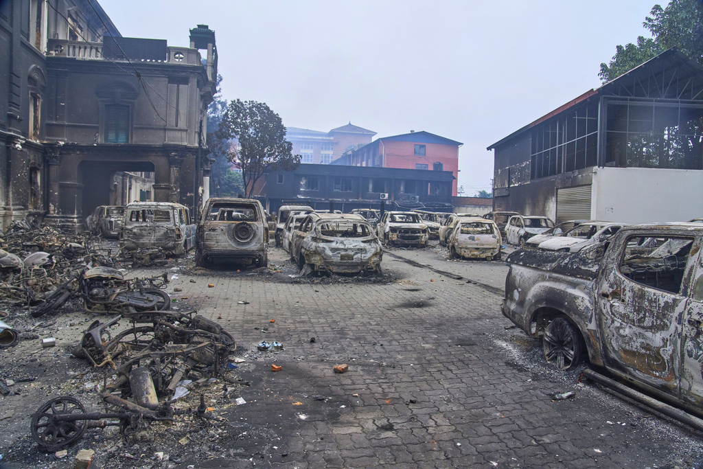 Vehicles stand burned inside the vandalised office of the Department of Roads in Kathmandu, Nepal, Wednesday, Sept. 10, 2025. (AP Photo/Niranjan Shrestha)