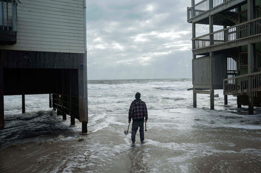 A worker who is reinforcing a home at risk of falling into the ocean looks out toward the waves as a storm approaches Friday, Oct. 10, 2025, in Buxton, N.C. (AP Photo/Allison Joyce) A worker who is reinforcing a home at risk of falling into the ocean looks out toward the waves as a storm approaches Friday, Oct. 10, 2025, in Buxton, N.C. (AP Photo/Allison Joyce)