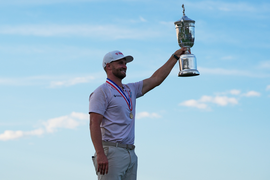 Wyndham Clark holds the trophy after winning the U.S. Open golf tournament at Shinnecock Hills Golf Club in Southampton, N.Y., Sunday, June 21, 2026. (AP Photo/Seth Wenig)
