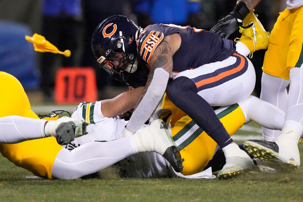 Green Bay Packers' Jordan Love is hurt as he is hit by Chicago Bears' Austin Booker during the first half of an NFL football game Saturday, Dec. 20, 2025, in Chicago. (AP Photo/Nam Huh)
