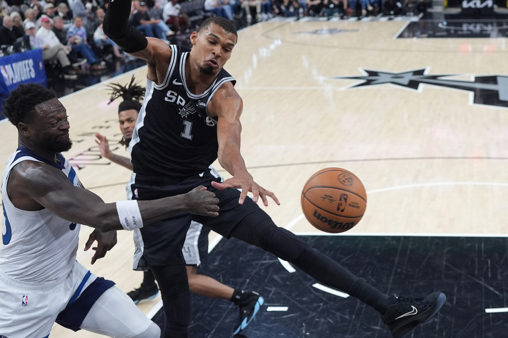 Minnesota Timberwolves forward Julius Randle (30) is blocked by San Antonio Spurs forward Victor Wembanyama (1) as he drives to the basket during the second half of Game 5 of an NBA basketball second-round playoffs series in Minneapolis, Tuesday, May 12, 2026. (AP Photo/Eric Gay)