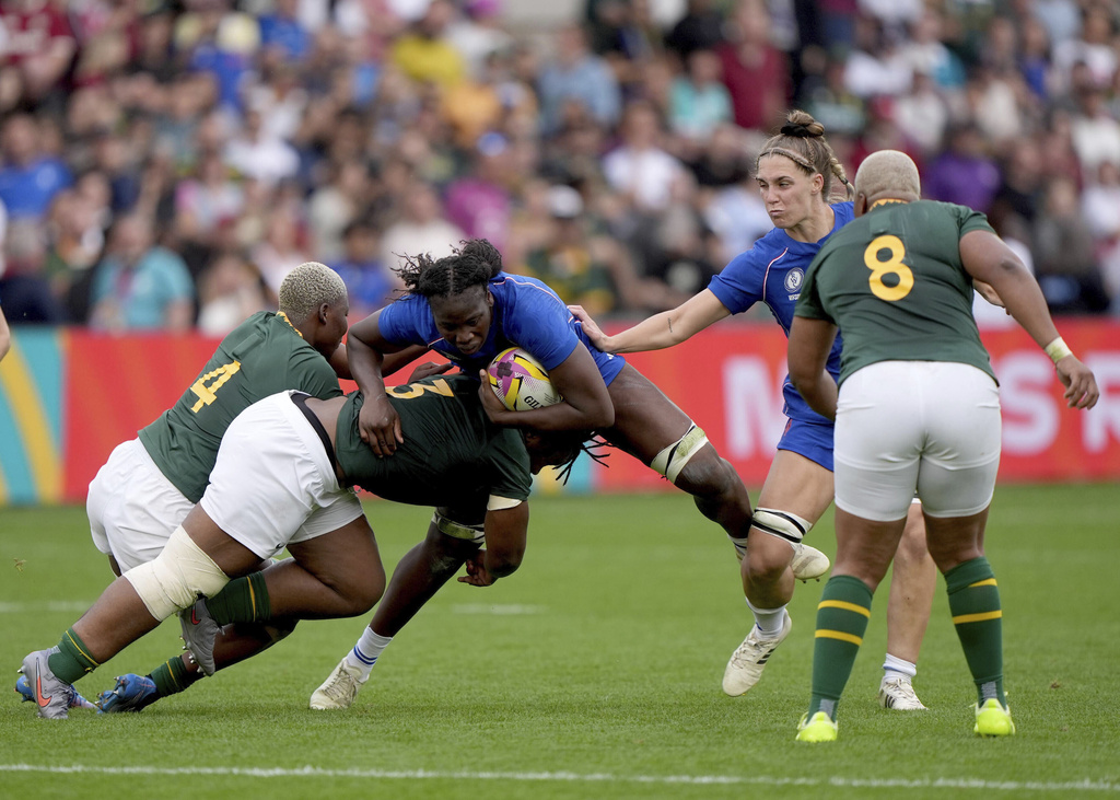 France's Madoussou Fall, center, is tackled by South Africa's Vainah Ubisi and Babalwa Latsha during the Women's Rugby World Cup 2025 pool D match between France and South Africa in Northampton, England, Sunday, Sept. 7, 2025. (Joe Giddens/PA via AP)