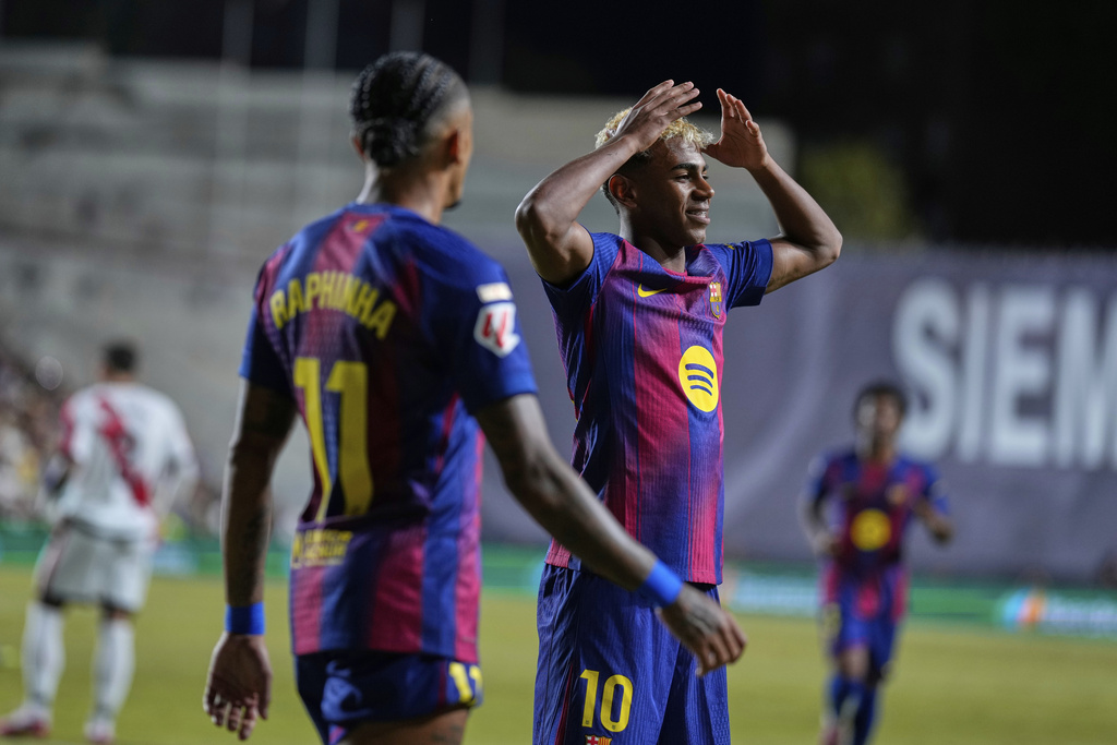 Barcelona's Lamine Yamal celebrates after scoring the opening goal from the penalty spot during the Spanish La Liga soccer match between Rayo Vallecano and FC Barcelona at the Vallecas stadium in Madrid, Spain, Sunday, Aug. 31, 2025. (AP Photo/Manu Fernandez)