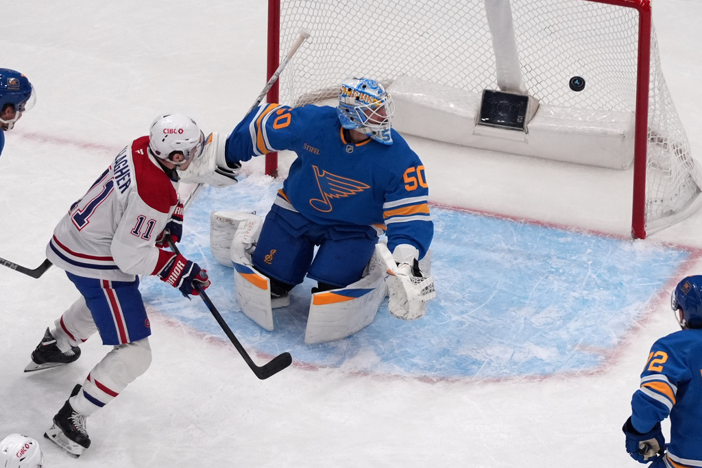 St. Louis Blues goaltender Jordan Binnington (50) and Montreal Canadiens' Brendan Gallagher (11) keep their eyes on the puck during the second period of an NHL hockey game Saturday, Jan. 3, 2026, in St. Louis. (AP Photo/Jeff Roberson)