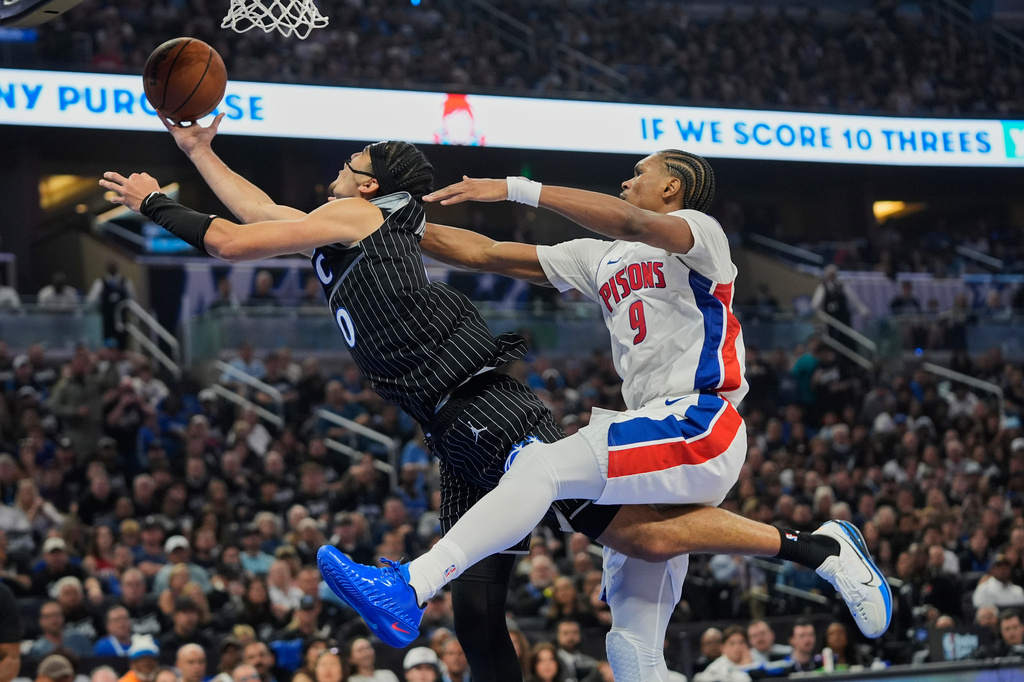 Detroit Pistons guard Ausar Thompson (9) fouls Orlando Magic guard Anthony Black (0) as he goes up for a shot during the second half in Game 3 of a first-round NBA basketball playoff series, Saturday, April 25, 2026, in Orlando, Fla. (AP Photo/John Raoux)
