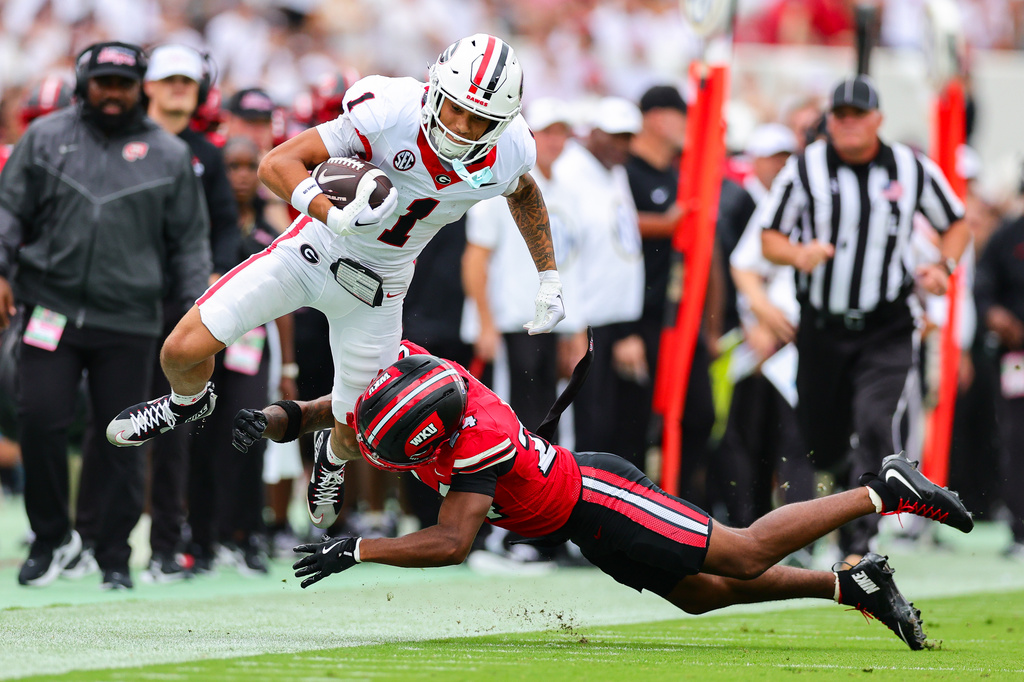 Georgia wide receiver Talyn Taylor (1) gets tackled by Western Kentucky defensive back Lataj Wright, right, during the first half of an NCAA college football game, Saturday, Sept. 12, 2026, in Athens, Ga. (AP Photo/Colin Hubbard)