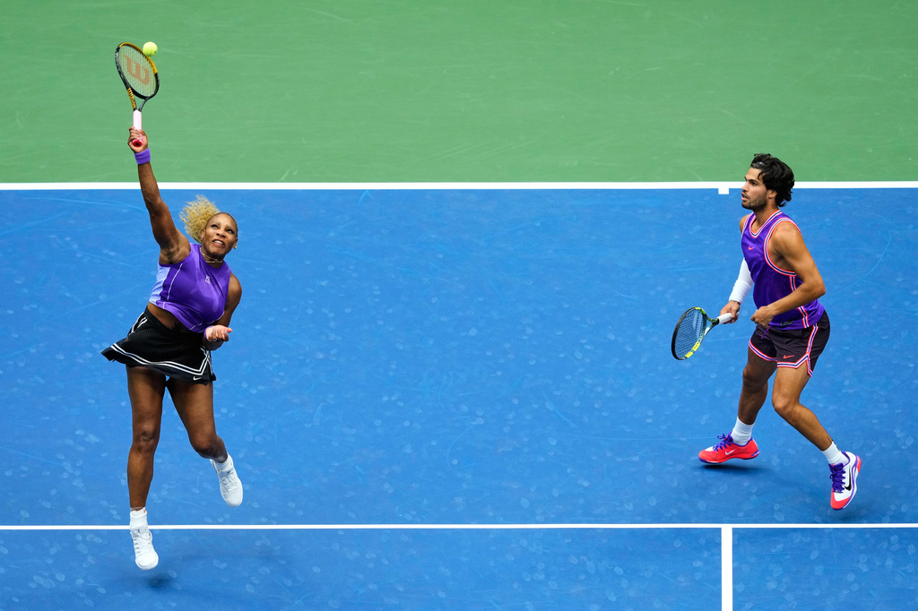 Serena Williams, of the United States, and Carlos Alcaraz, of Spain, return the ball during a mixed doubles match at the U.S. Open tennis championships, Tuesday, Aug. 25, 2026, in New York. (AP Photo/Yuki Iwamura)