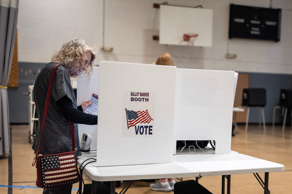 Marylou Zschach fills out her ballot at her polling place at the Burbank Early Childhood School in Columbus, Ohio, Tuesday, May 5, 2026, during the primary election. (AP Photo/Carolyn Kaster)