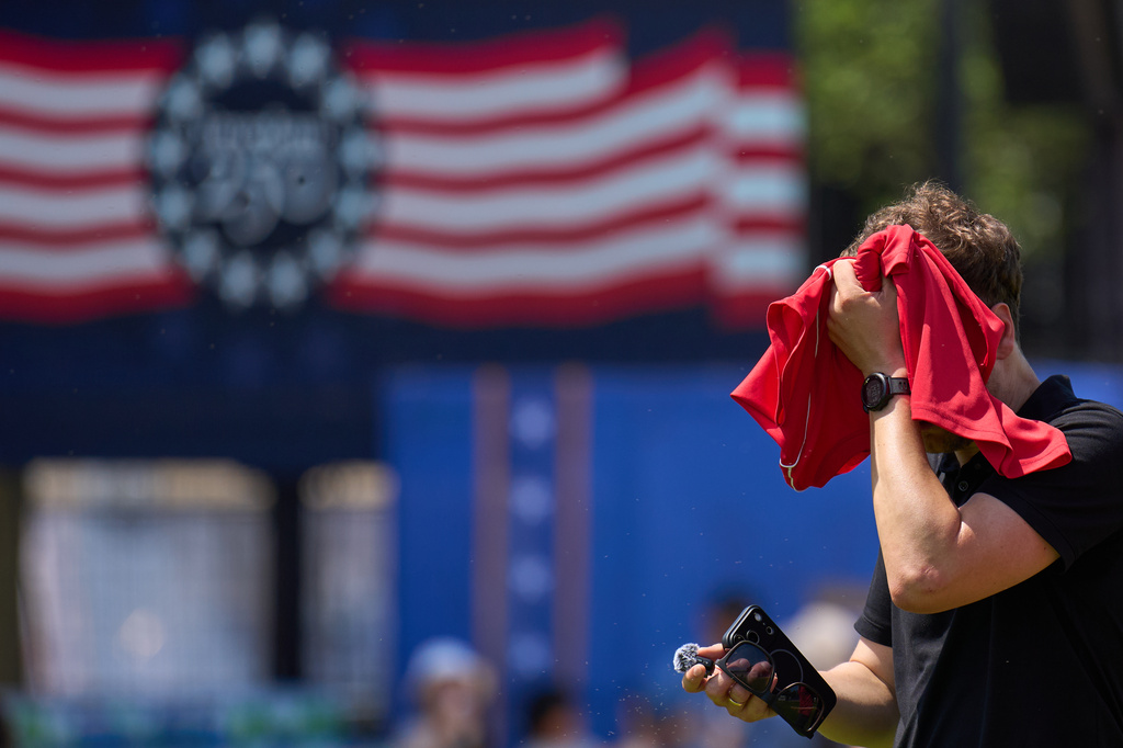 A man wipes sweat off of his head while attending the Great American State Fair, on the National Mall, Wednesday, July 1, 2026, in Washington. (AP Photo/Jacquelyn Martin)